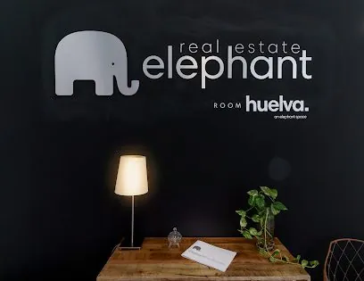 Elephant Real Estate - Room Huelva, inmobiliaria